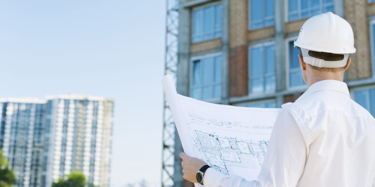 back-view-man-holding-building-plans (1)